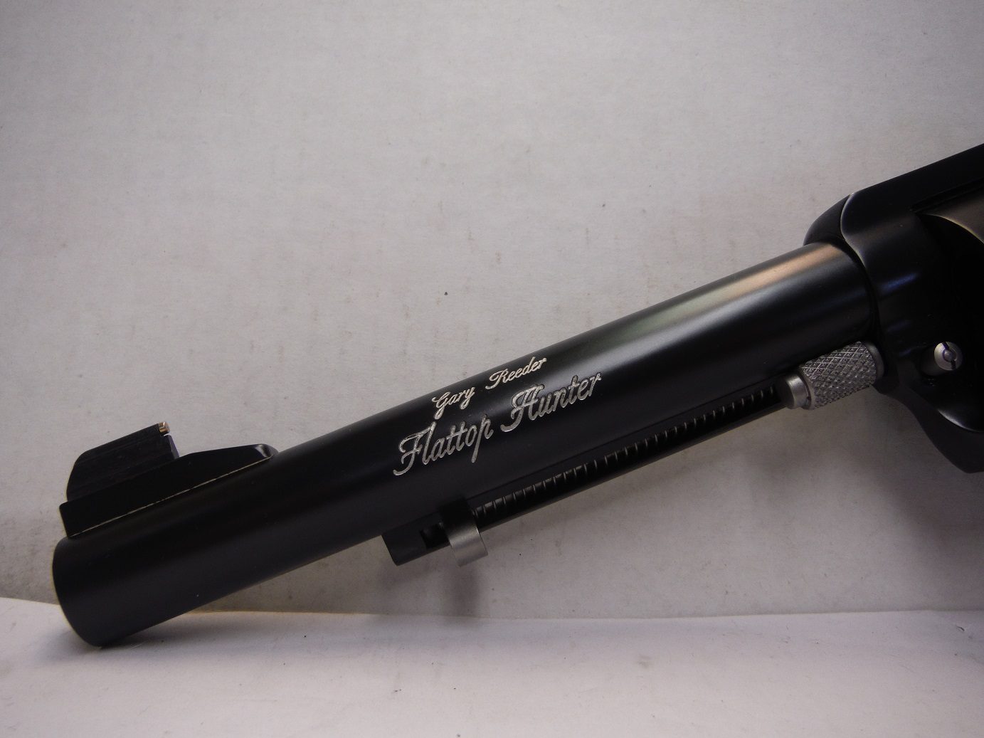 A black gun that is sitting on the ground.