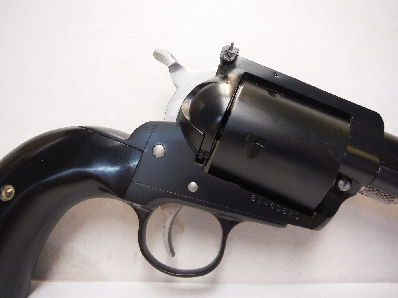 A black revolver with a white background