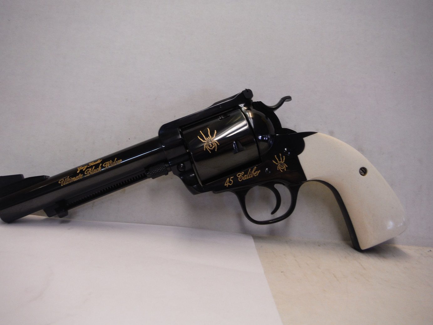 A black and white gun with a gold design on it.