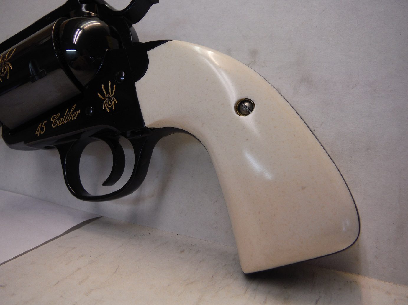 A white gun is laying on the floor