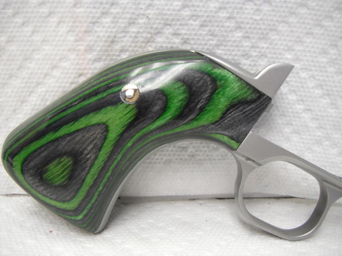 A green and black gun is on the table