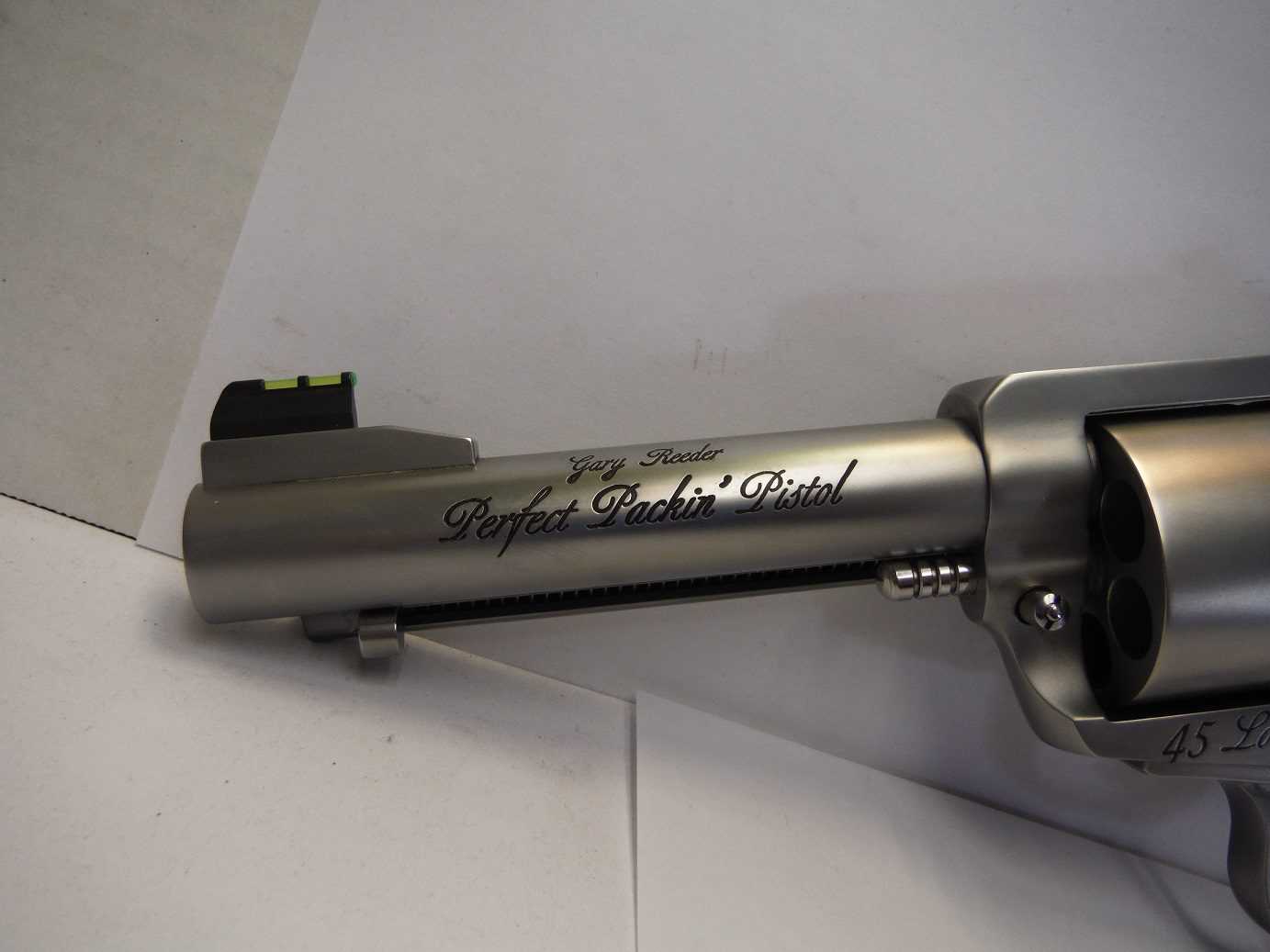 A gun that is sitting on top of a wall.