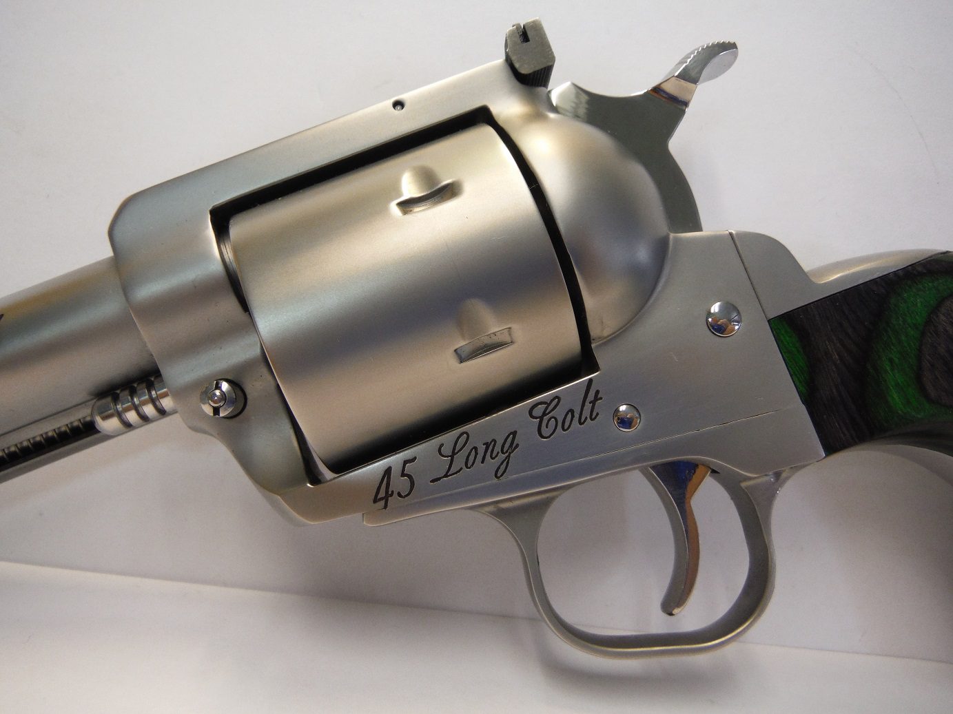 A silver gun with the words " 4 5 long colt ".