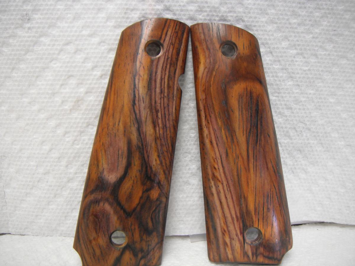 A pair of wooden grips for a gun.