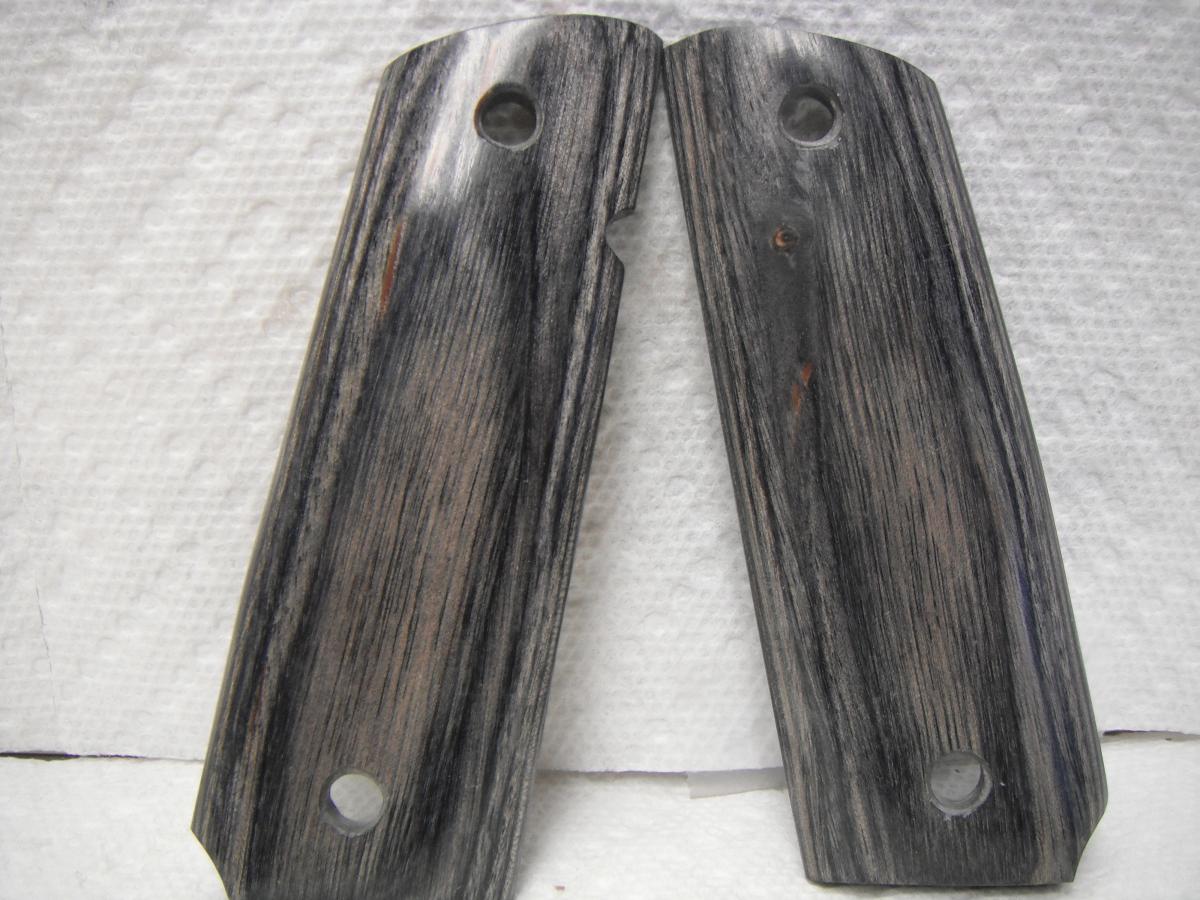 A pair of wooden grips on top of a table.