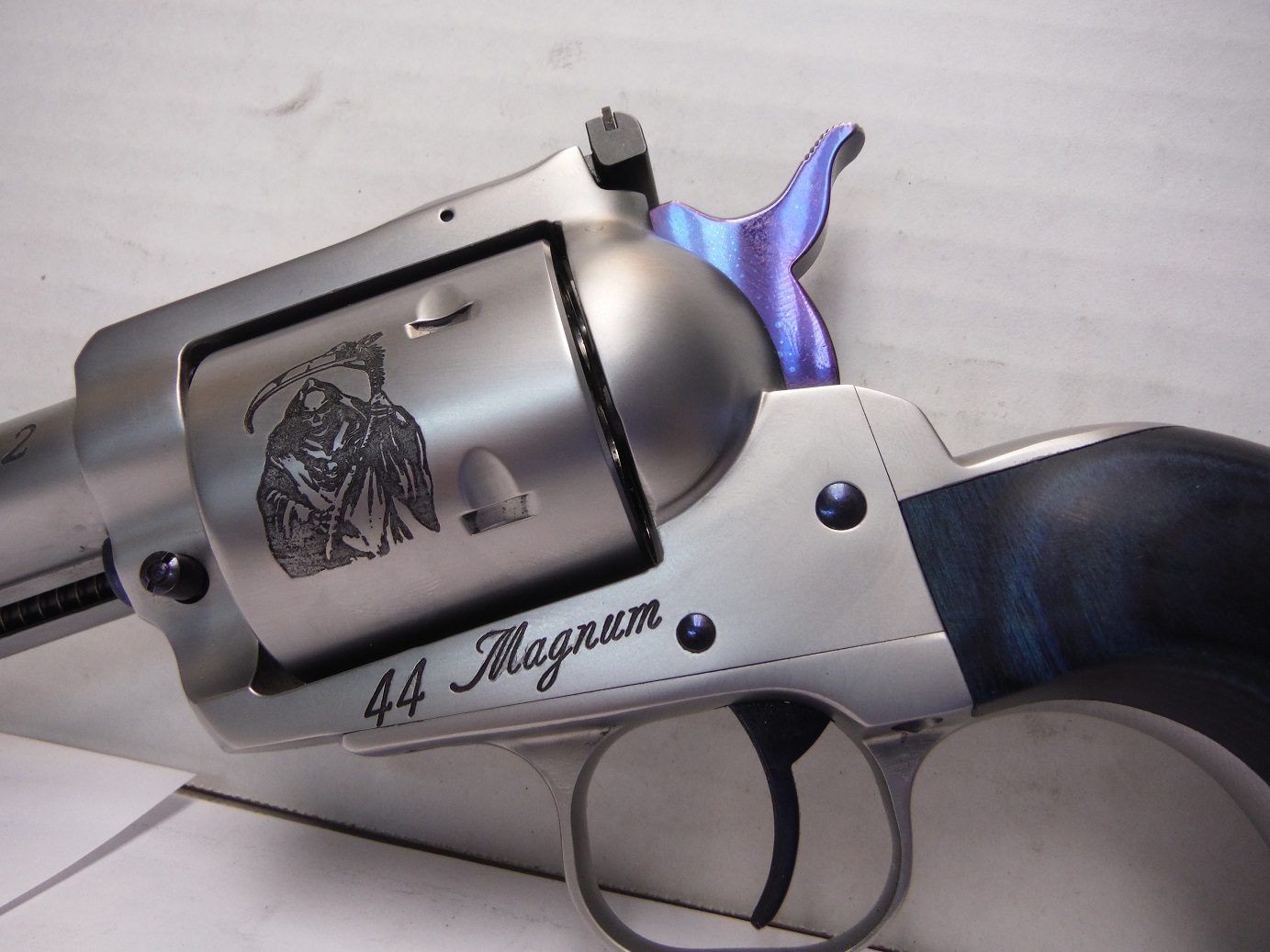 A silver and blue gun with the words " 4 4 magnum ".