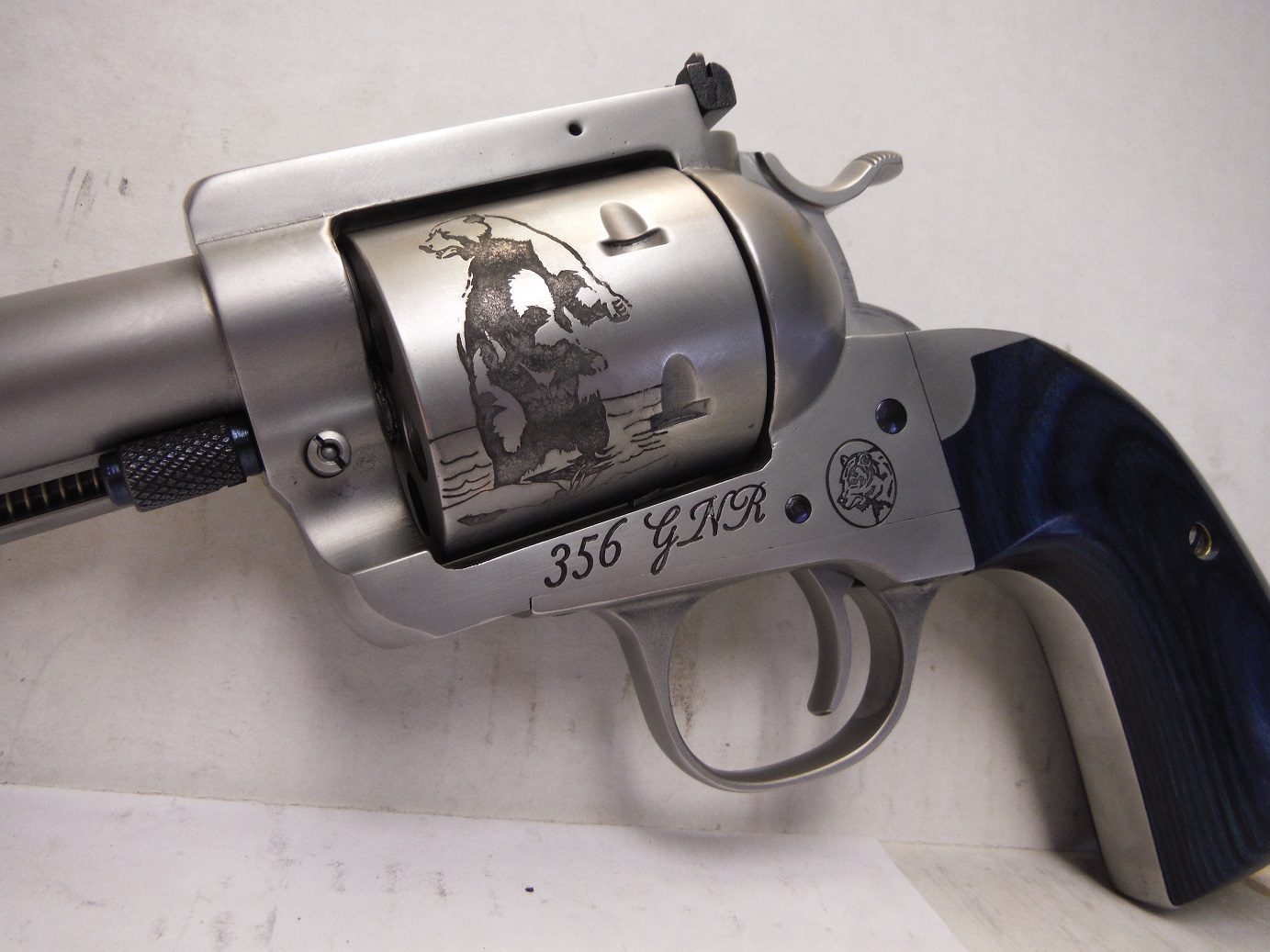 A gun that has been engraved with an image of a cow.