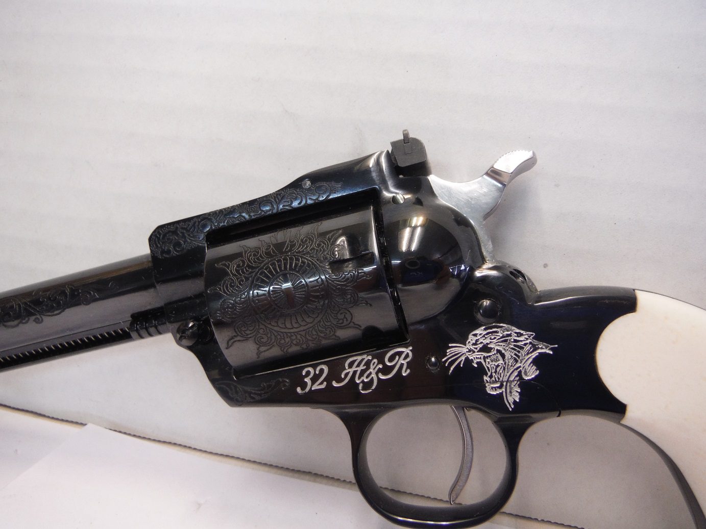 A black and silver gun with a white background
