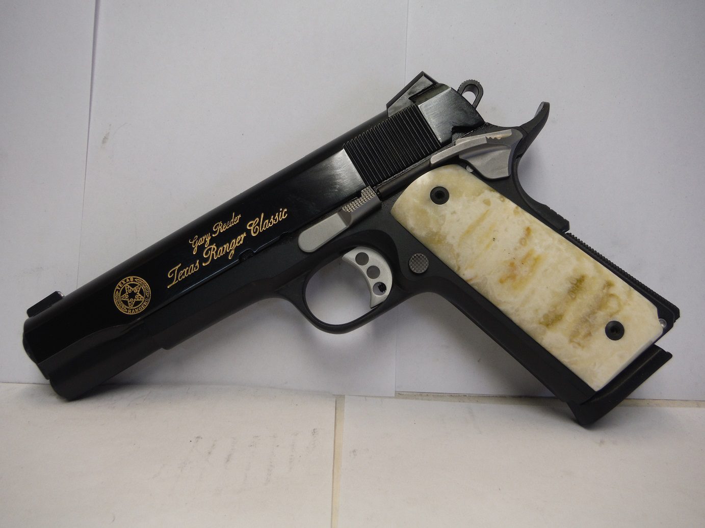 kolar-1 A black and white gun with a bone handle.