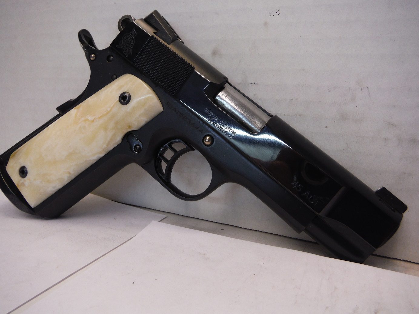A black and white gun sitting on top of a table.