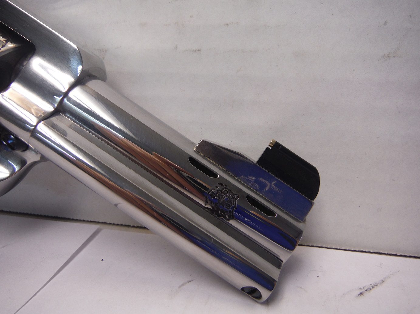 A close up of the side of a chrome pipe