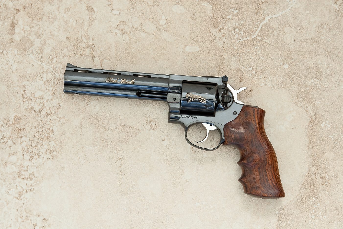 A gun that is on the ground with its grips.