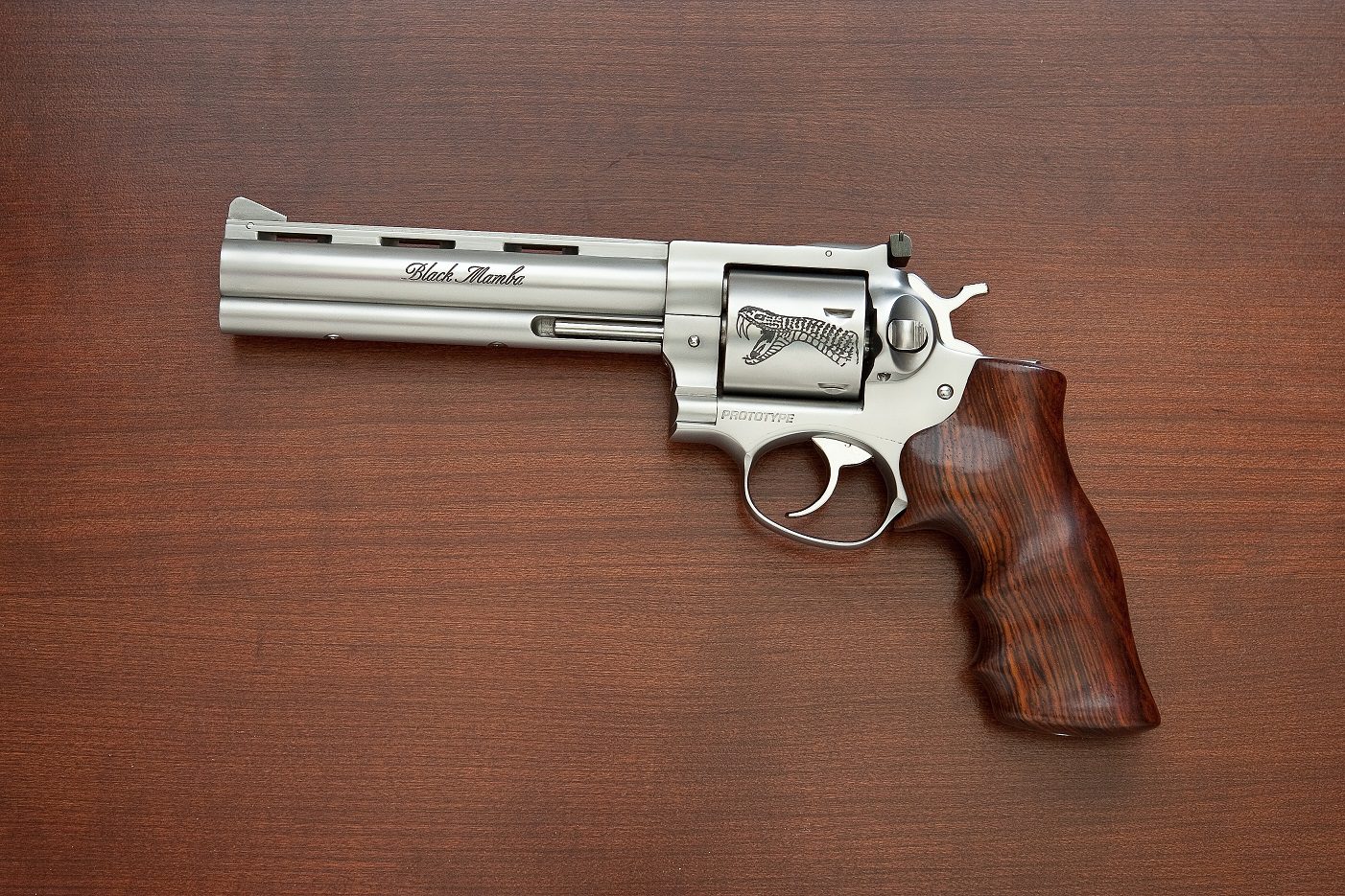 A silver and wood gun is on top of the table.
