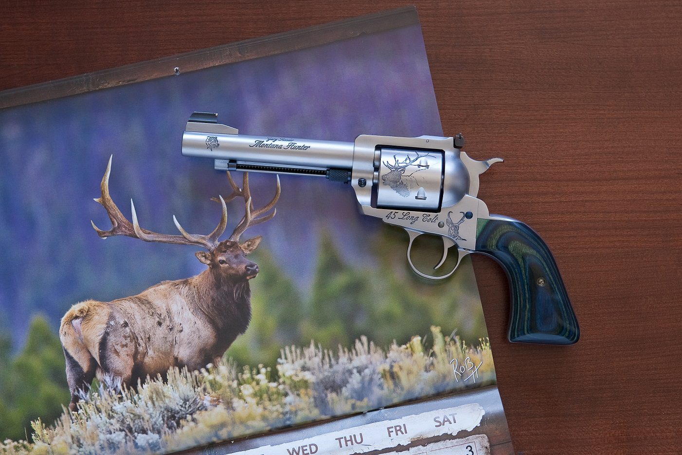 A gun sitting on top of a book.