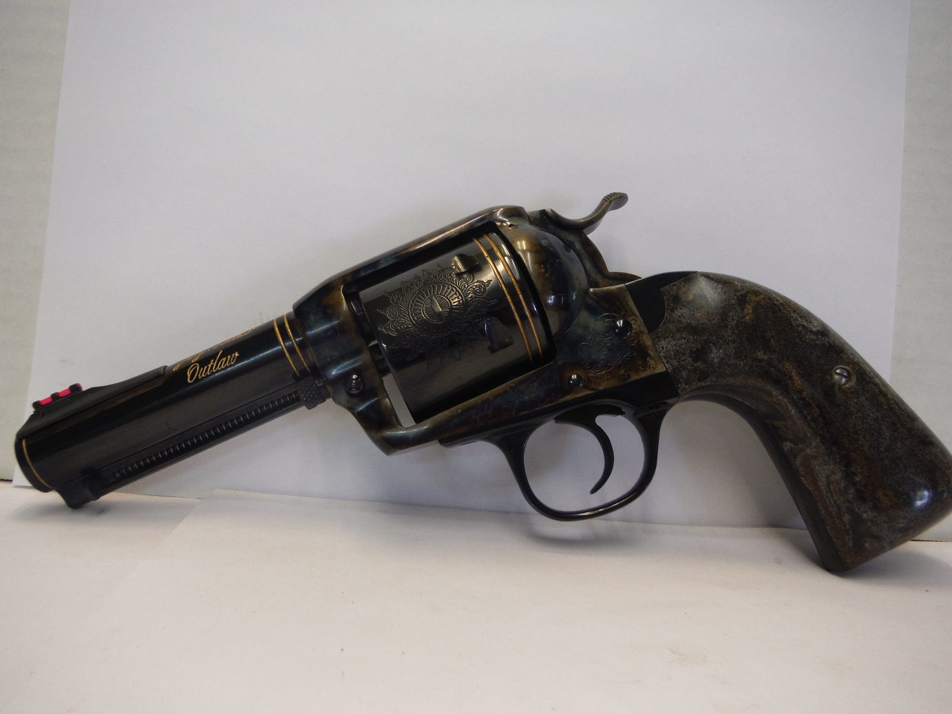 A black and gold gun is on the floor