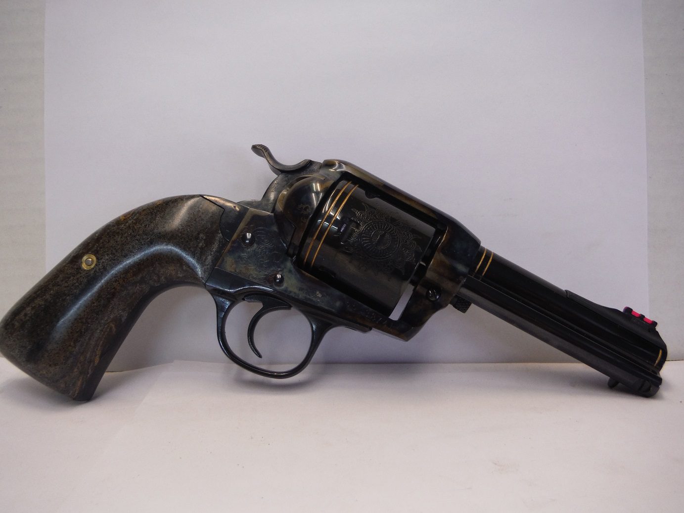 A black and gold gun is on the floor