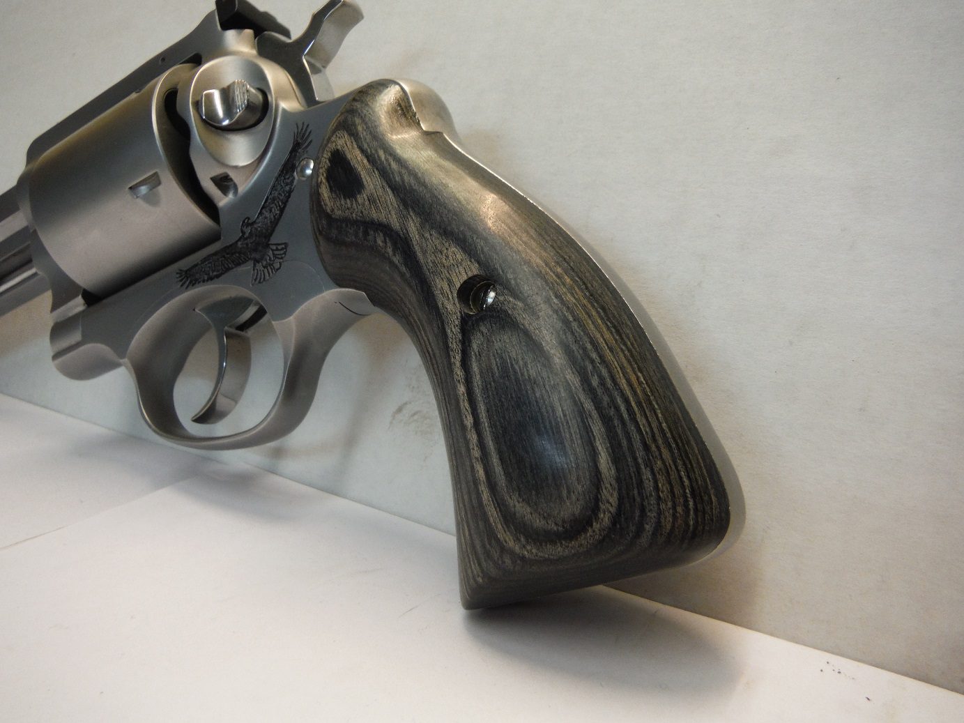 A gun that is leaning against the wall.
