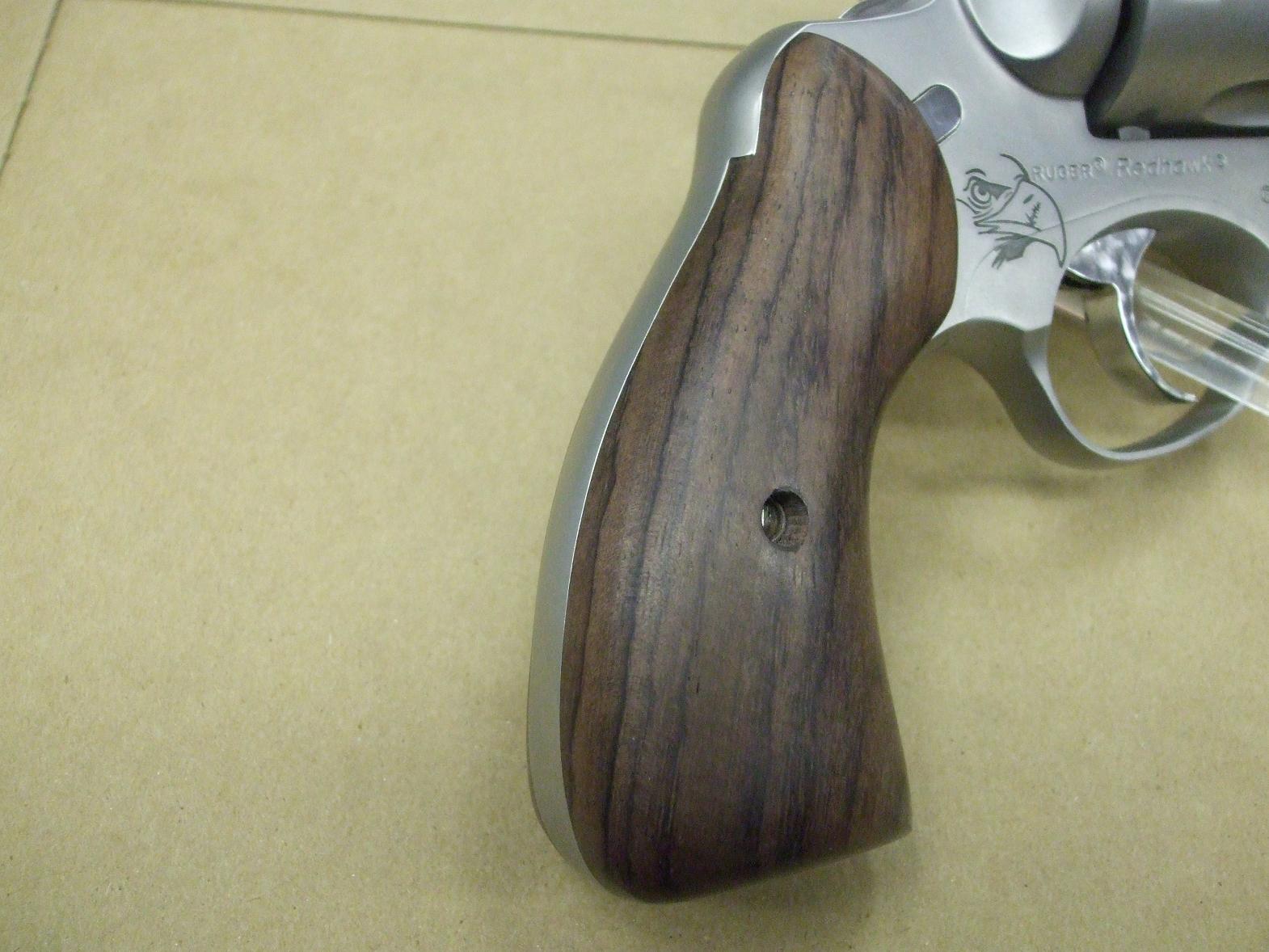 A close up of the wood on the handle of a gun.