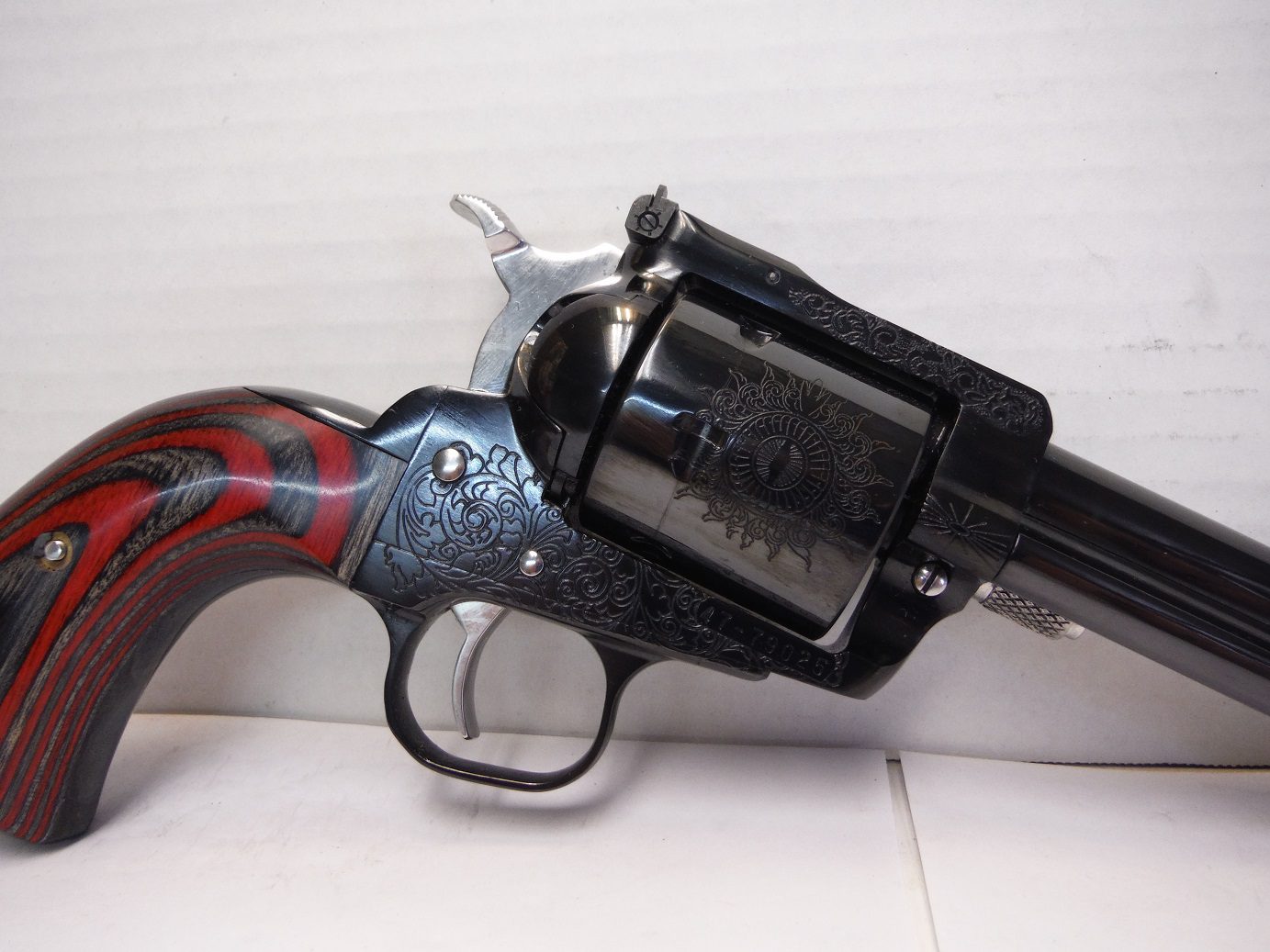 A black and red revolver is on the floor